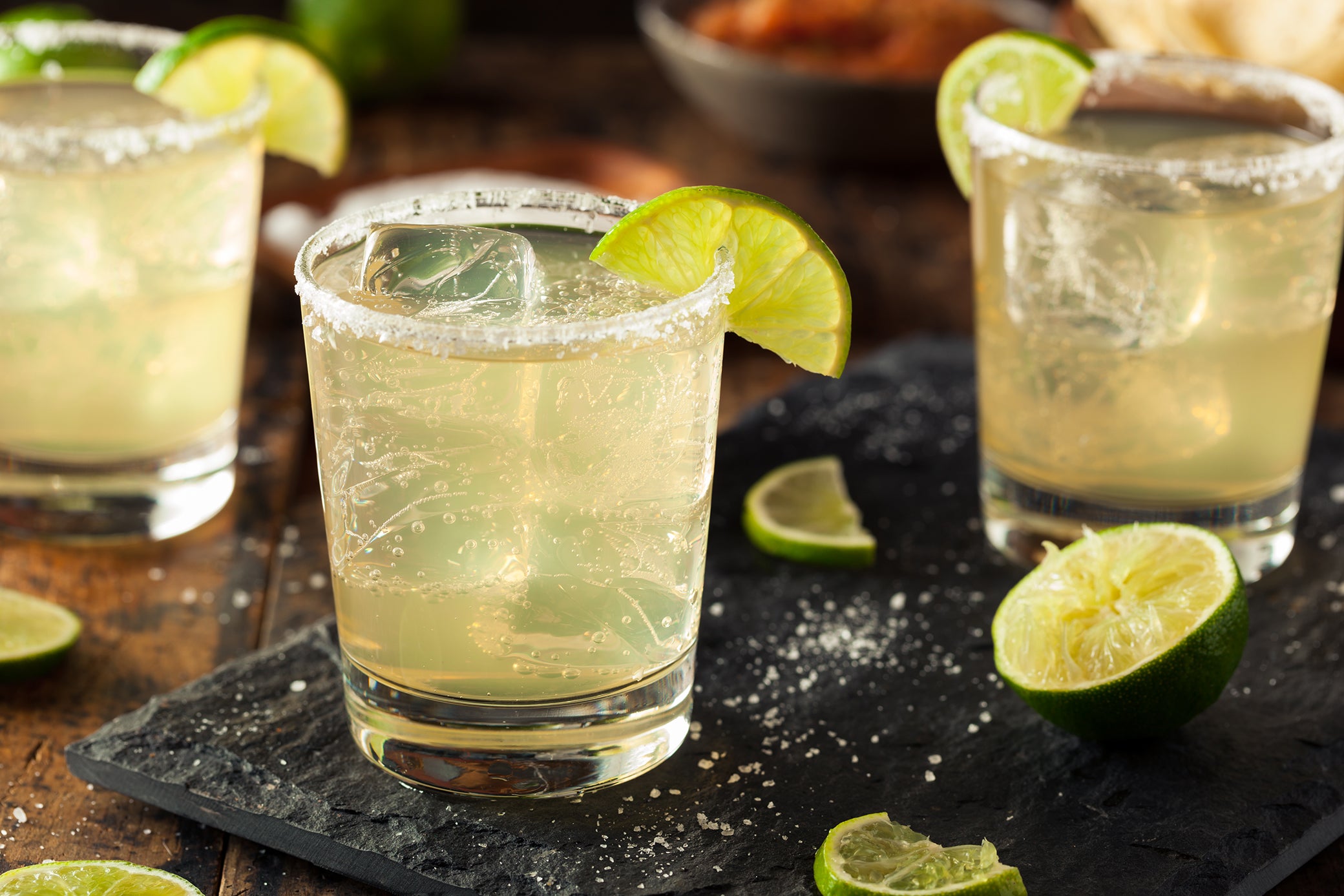 Margarita cocktail on a slate board with other margaritas.