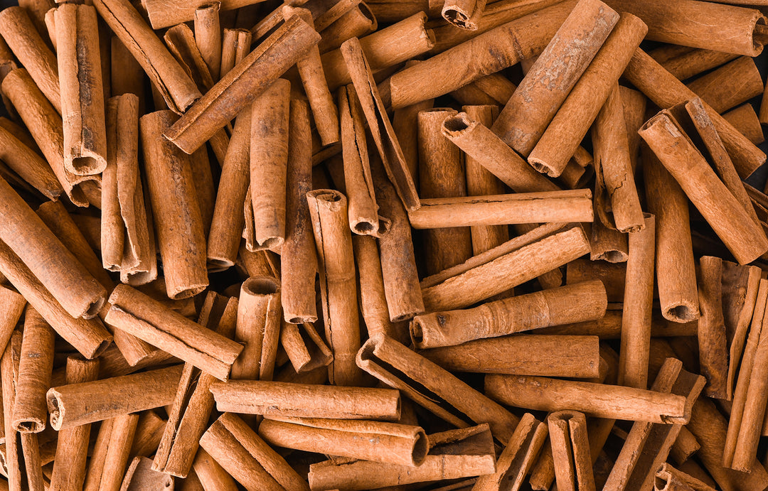 A very large amount of cinnamon sticks laying on top of each other. An ingredient in Bermuda Bitters.